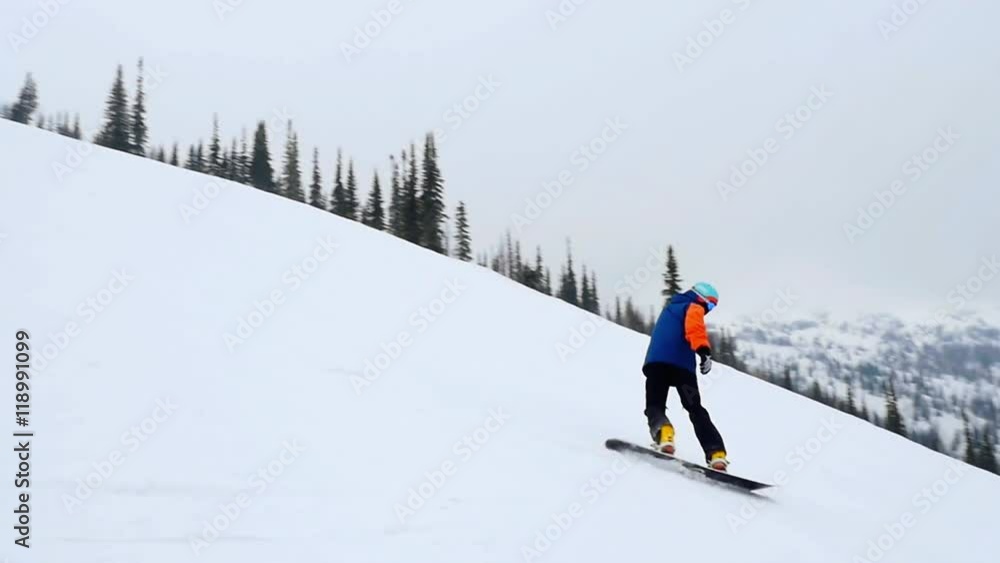Cool snowboarder on the slope at a ski resort in slowmotion. 1920x1080 Cool snowboarder on the slope at a ski resort in slowmotion. 1920x1080