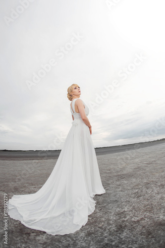 Beautiful bride outdoors in a desert.