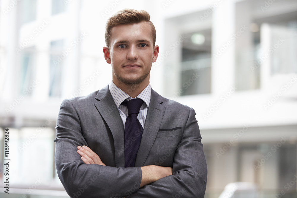 Head And Shoulders Portrait Of Young Businessman In Office Head And Shoulders Portrait Of Young Businessman In Office
