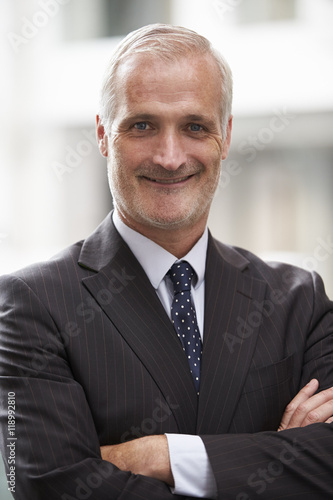 Head And Shoulders Portrait Of Mature Businessman In Office