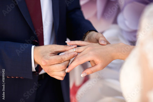 Bride and groom exchanging of wedding rings at wedding ceremony