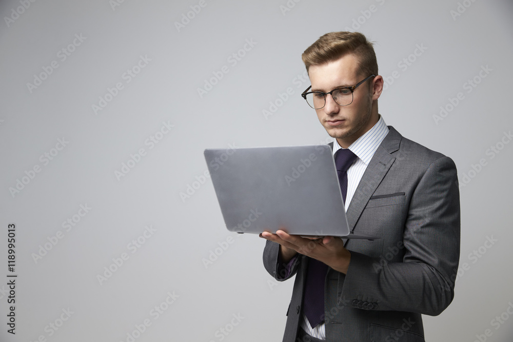 Studio Portrait Of Businessman Using Laptop Studio Portrait Of Businessman Using Laptop