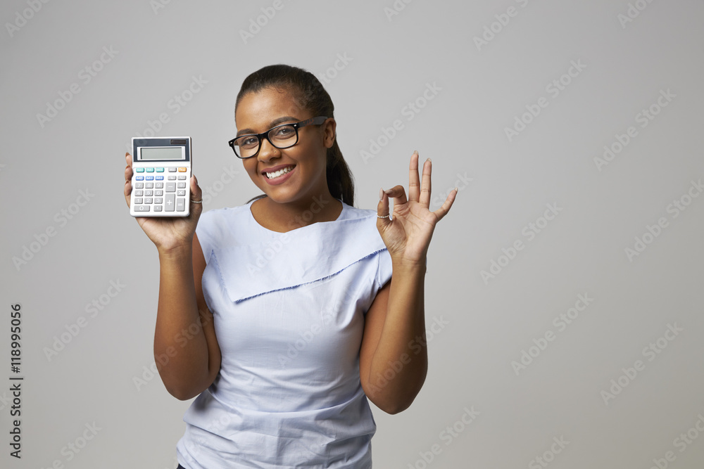 Studio Portrait Of Female Accountant Using Calculator Studio Portrait Of Female Accountant Using Calculator