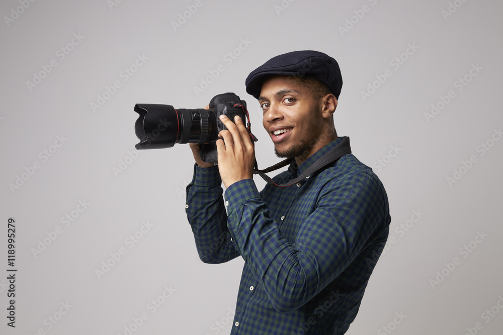 Studio Portrait Of Male Photographer With Camera Studio Portrait Of Male Photographer With Camera