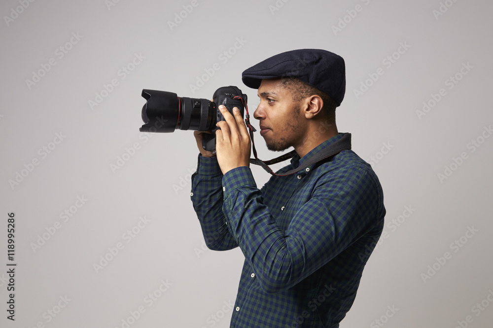 Studio Portrait Of Male Photographer With Camera Studio Portrait Of Male Photographer With Camera