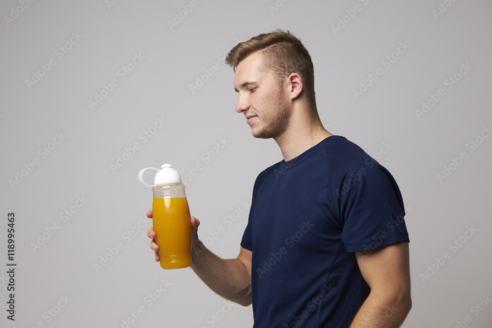 Studio Portrait Of Male Nutritionist With Drinks Bottle Studio Portrait Of Male Nutritionist With Drinks Bottle