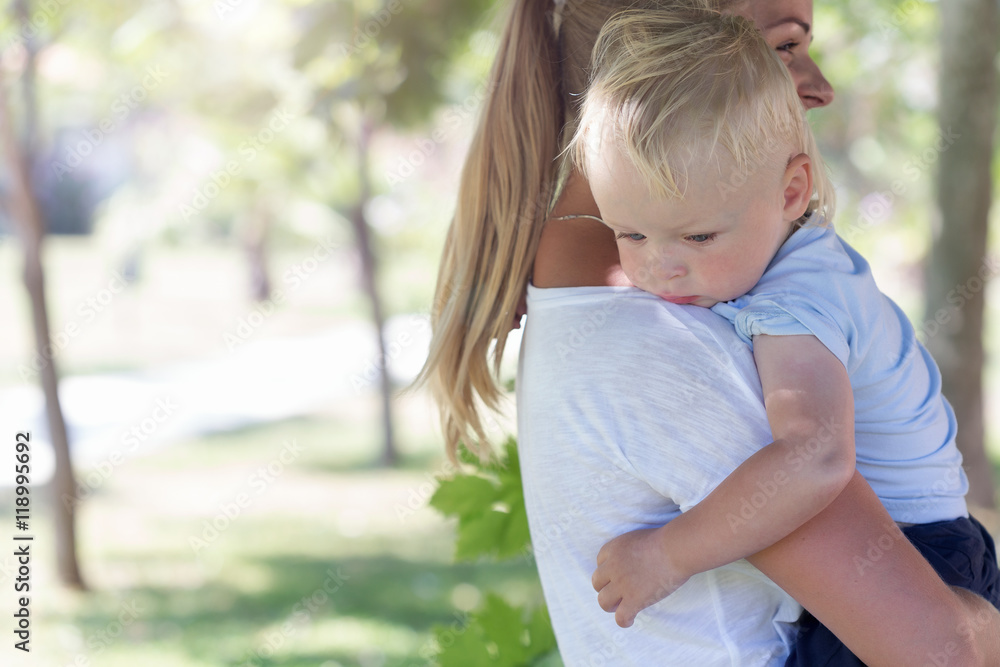 Mother hugging a blond boy Mother hugging a blond boy