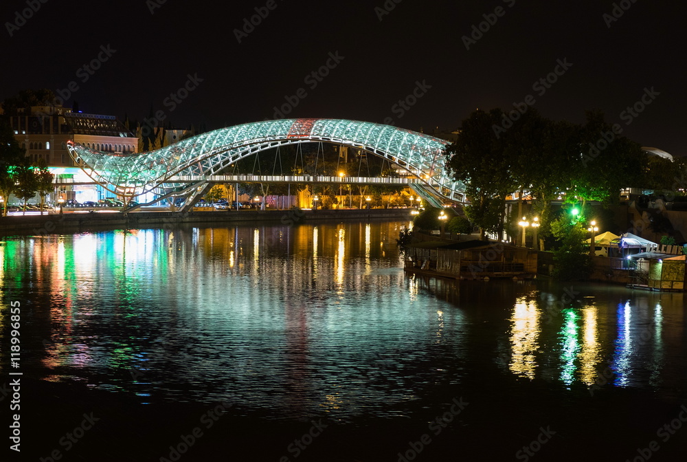 Bridge of Peace reflected in river Mtkvari (Kura). Tblisi, Georg
