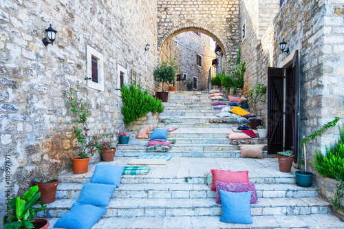 Stairs with pillows and stone arch in Ulcinj Old Town, Montenegro. photo