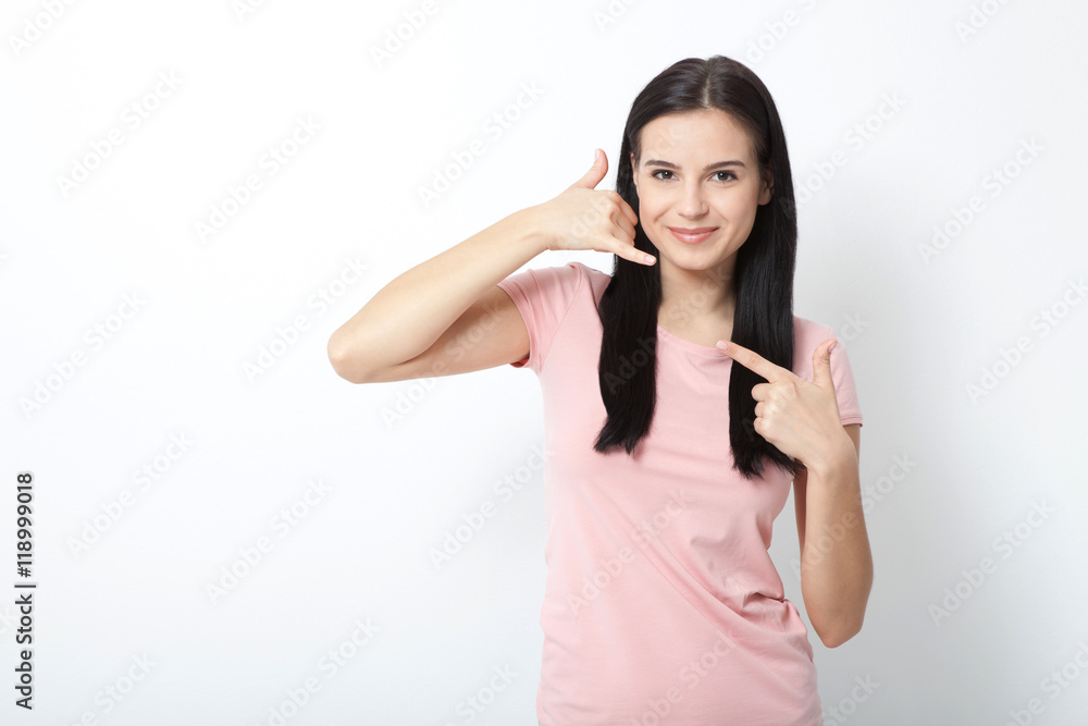 Call me. Woman showing sign and smiling on white. Call me. Woman showing sign and smiling on white.