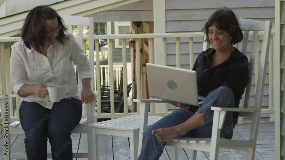 Middle aged woman and her daughter using laptop at home - 4K Middle aged woman and her daughter using laptop at home - 4K