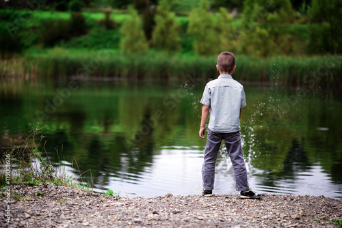 boy throws a stone into the water 