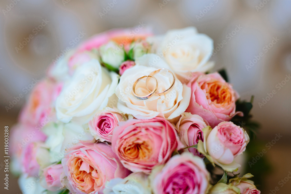 Wedding rings on a bouquet of roses, close-up Wedding rings on a bouquet of roses, close-up