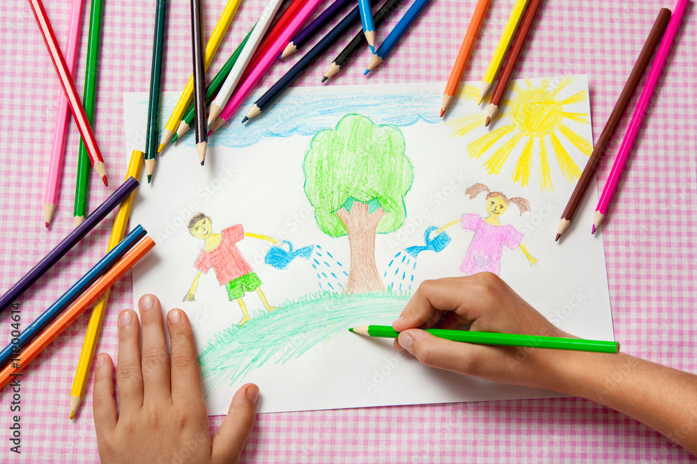 Child paints a picture of pencils about protecting nature. Child paints a picture of pencils about protecting nature.