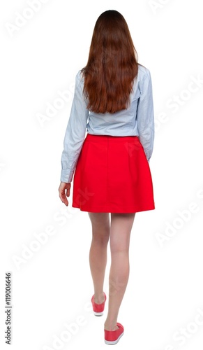back view of walking woman. beautiful blonde girl in motion. backside view of person. Isolated over white background.