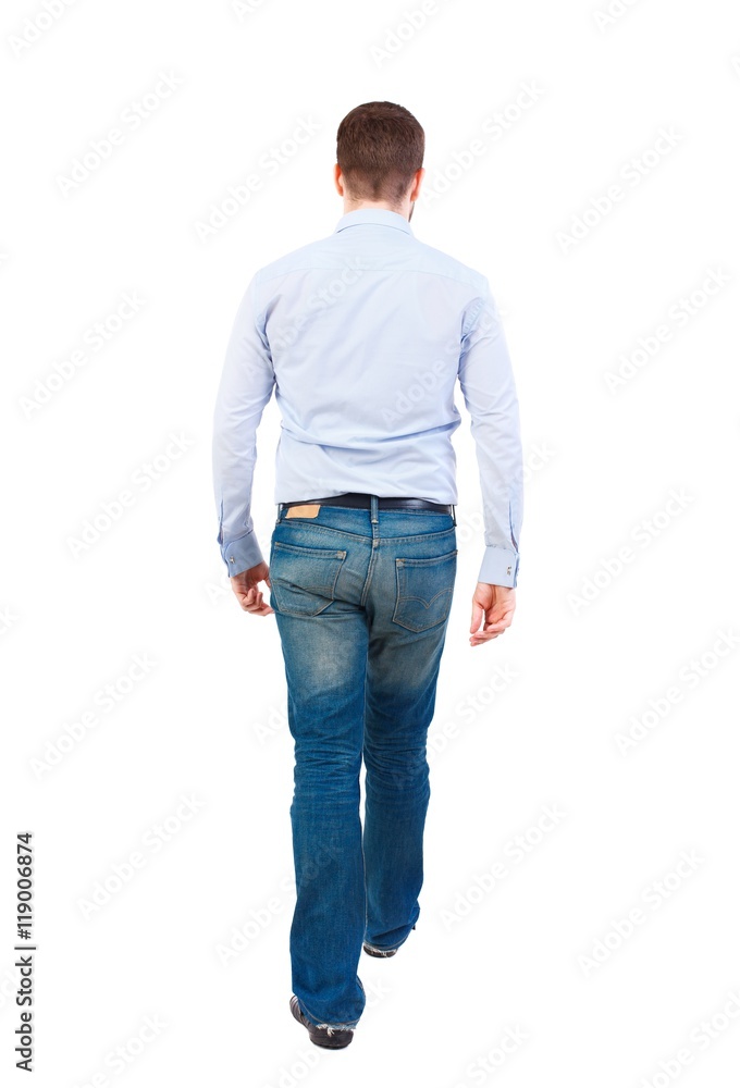 Back view of walking businessman. Bearded businessman in a white shirt out of the frame. Back view of walking businessman. Bearded businessman in a white shirt out of the frame.