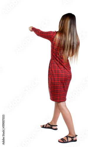 skinny woman funny fights waving his arms and legs. girl in red plaid dress punches.
