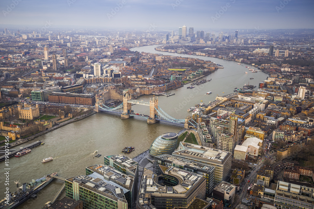 London, England - Aerial Skyline view of London with the iconic Tower Bridge, Tower of London and skyscrapers of Canary Wharf at dusk