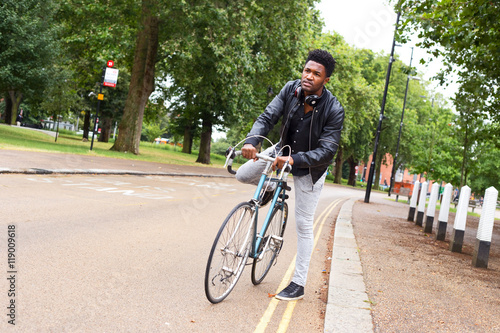young man in a hurry getting on his bike