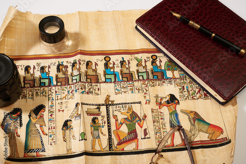 Egyptian papyrus, notepad, pen, lens