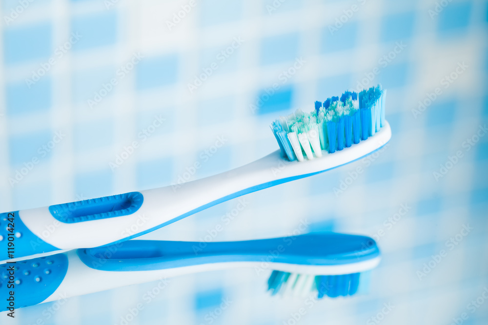 toothbrush on blue tile background toothbrush on blue tile background