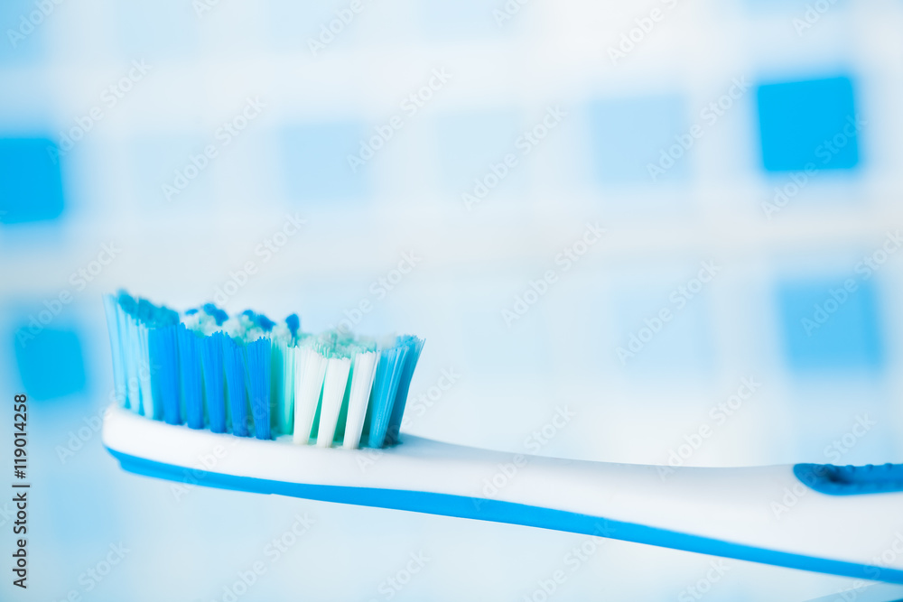 toothbrush on blue tile background toothbrush on blue tile background