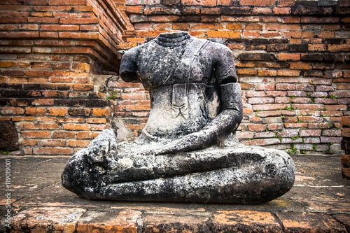 Old buddha statue and pagoda at Wat Chaiwatthanaram in the Ayutthaya Historical Park, Ayutthaya, Thailand. photo