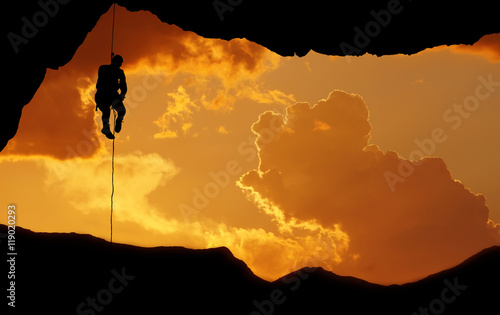 Silhouette of a climber over beautiful sunset