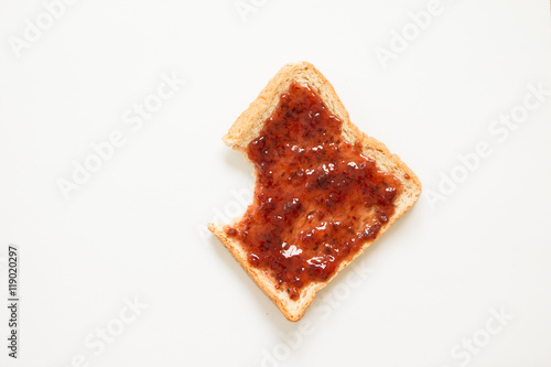 Bitten bread with strawberry jam photo