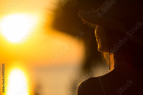 young woman staying back of the head in summer light