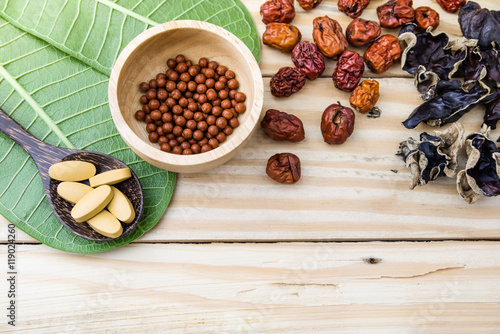 Принти на полотні Alternative medicine,  herbs, herbal pills, tablets on wood back