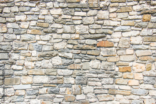 Close up of an ancient stone wall. Stone wall background.