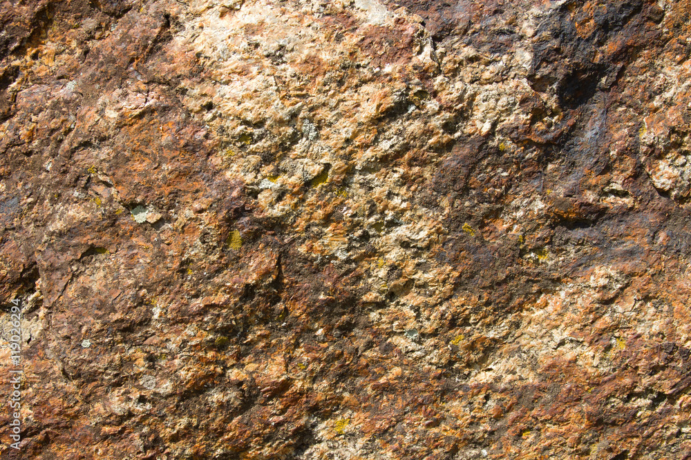 Bright brown granite texture with natural pattern. Background of natural stone.
