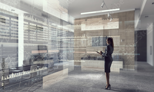 Businesswoman in modern office interior . Mixed media