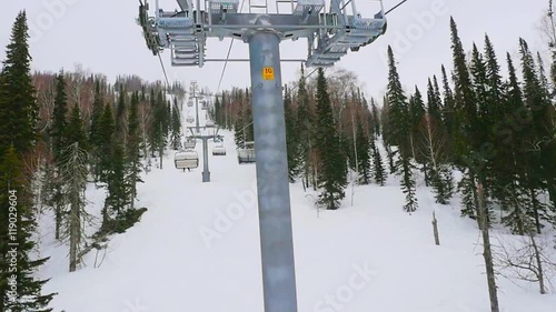 Ski lift chairs on snowstorm winter day. 1920x1080