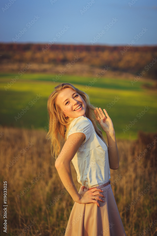 Tender blonde poses in white t-shirt and beige skirt before the Tender blonde poses in white t-shirt and beige skirt before the
