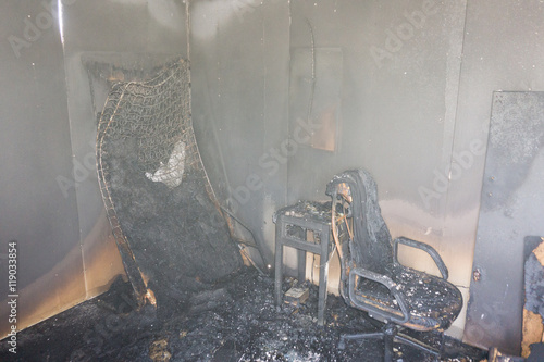 Slika na platnu chair and furniture in room after burned by fire with smoke and