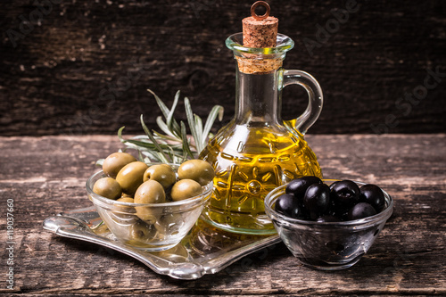 Olive oil on wooden table , food concept