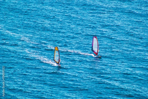 Surfers on blue sea