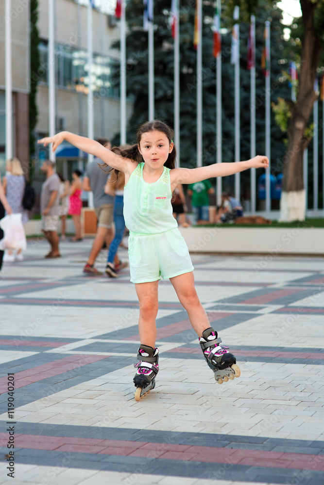Little pretty girl on roller skates at a park Little pretty girl on roller skates at a park