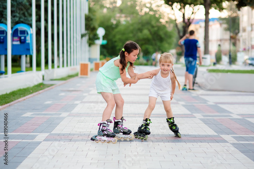 two beautiful little sisters in a roller skates