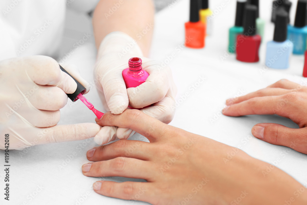 Woman getting a manicure in a beauty salon, close up Woman getting a manicure in a beauty salon, close up