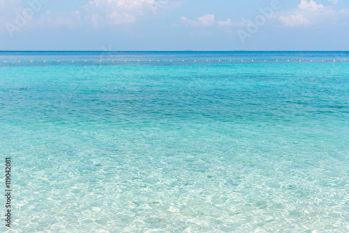 Beautiful white sand on Tropical beach blue water and blue sky © joneyut