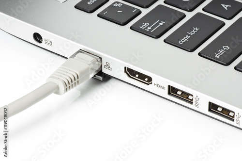 Fotografie LAN. plug inserted into the port at the side of computer notebook
