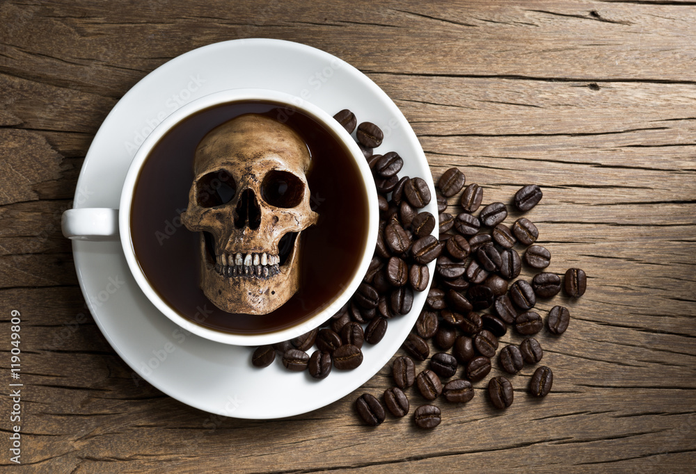 Still life photography human skull soak in white coffee cup in