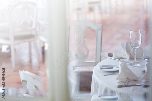 View through the glass at restaurant. Interior in white tones