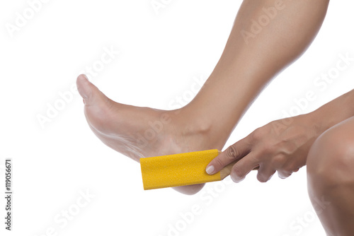 Woman scrubbing her heel with foot rasp isolated on white background.