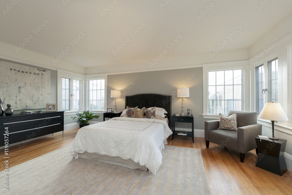 Fototapeta premium Simple Modern Bedroom with Full Bed and Wooden Floors