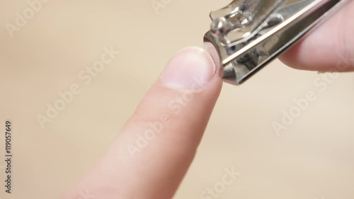 Metal nail clipper close-up taking nails and hands hygiene 4K 3840X2160 UltraHD video - Trimming fingernails with nail trim shallow DOF 4K 2160p 30fps UHD footage  photo