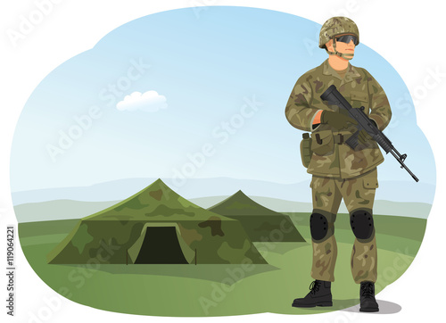 Soldier in uniform, ready to fight. Army camp. Military tents on the background.
